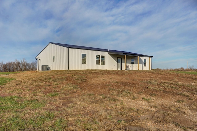 rear view of property featuring central air condition unit