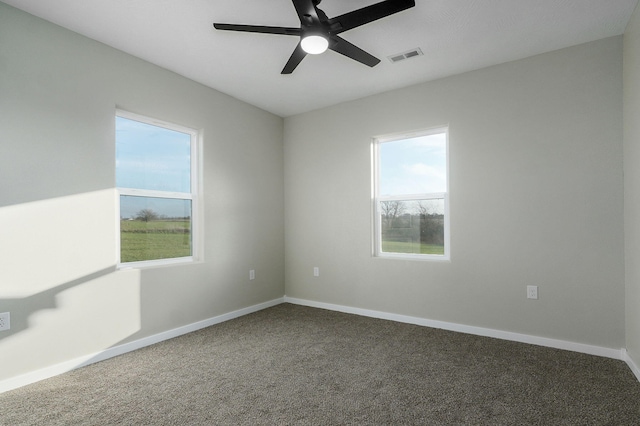 spare room with carpet, ceiling fan, and a healthy amount of sunlight