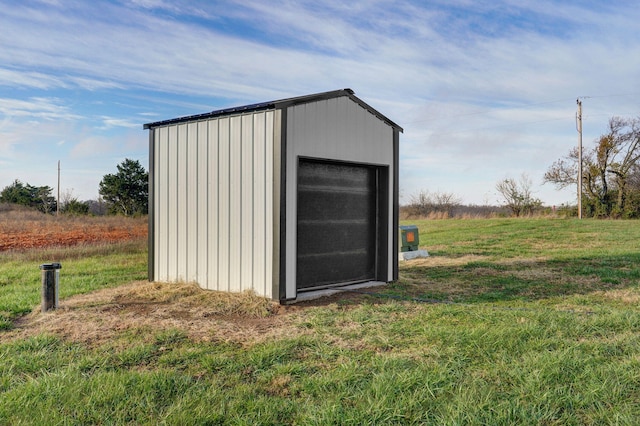 view of outbuilding with a yard and a rural view