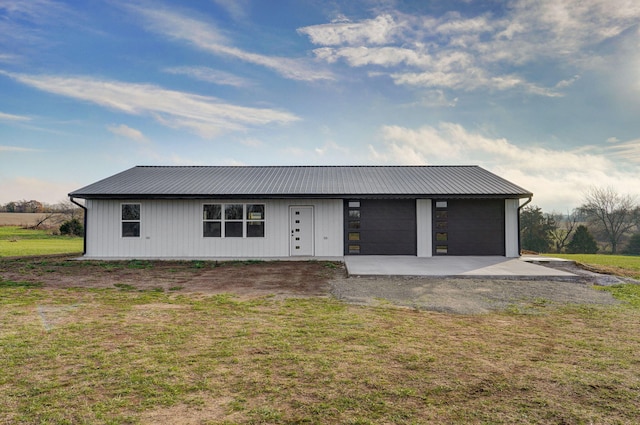 single story home with a garage and a front yard