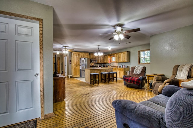 living room with light hardwood / wood-style flooring and a notable chandelier