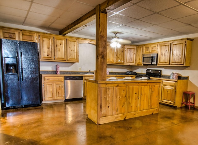 kitchen with a paneled ceiling, sink, black appliances, beam ceiling, and a kitchen island