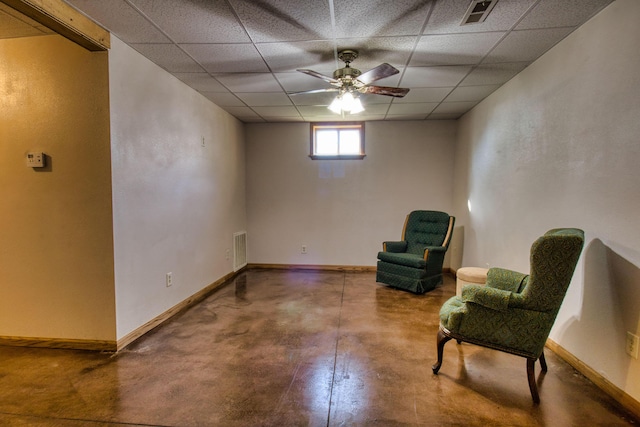 living area with a paneled ceiling