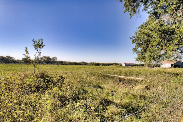 view of yard with a rural view