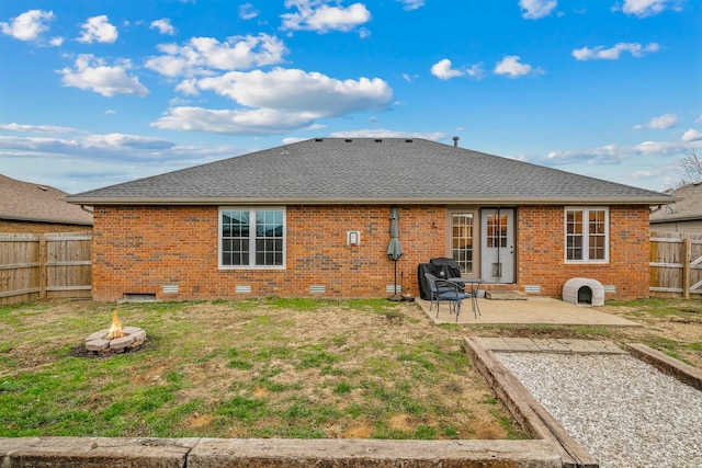 rear view of house with a yard and a patio