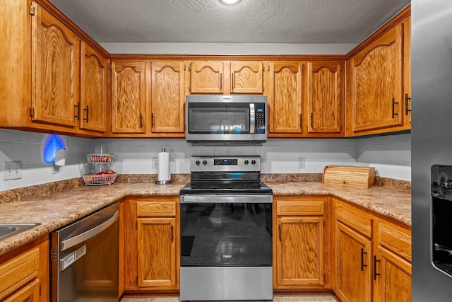 kitchen with decorative backsplash and appliances with stainless steel finishes