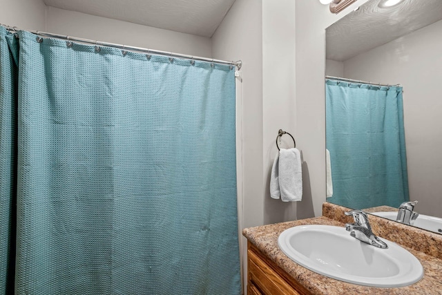 bathroom featuring vanity and a textured ceiling