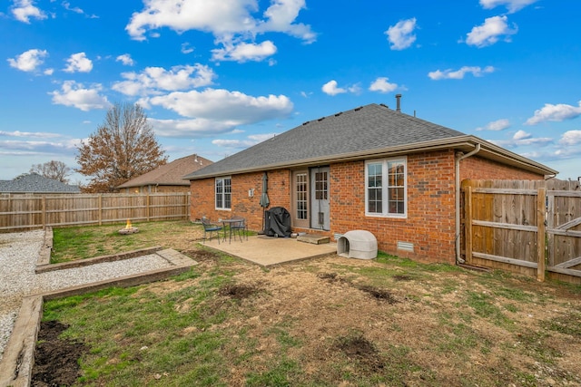 rear view of house featuring a yard and a patio