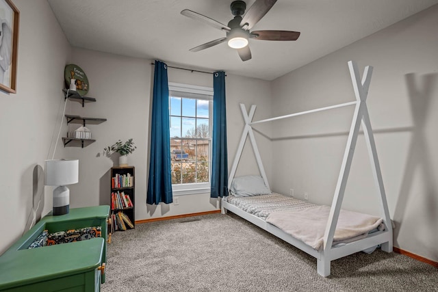 bedroom featuring ceiling fan and carpet