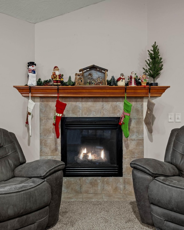 interior space featuring a textured ceiling and a tiled fireplace