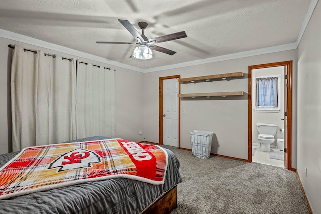 carpeted bedroom featuring a textured ceiling, ensuite bathroom, ceiling fan, and ornamental molding