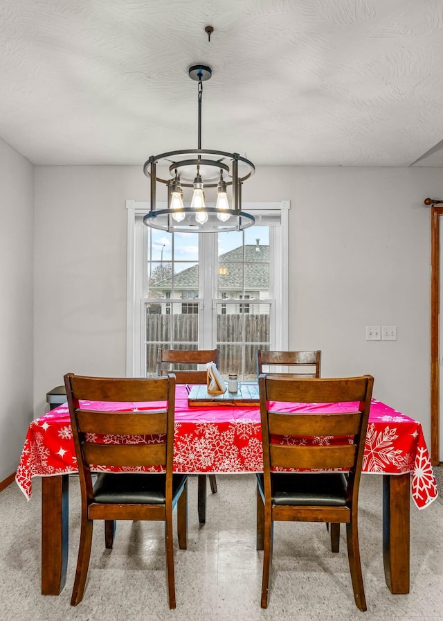 dining room with a textured ceiling and an inviting chandelier