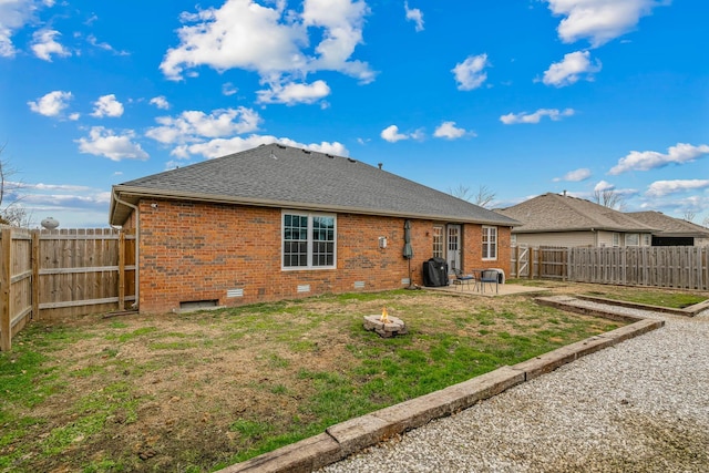 rear view of house with a yard and a patio