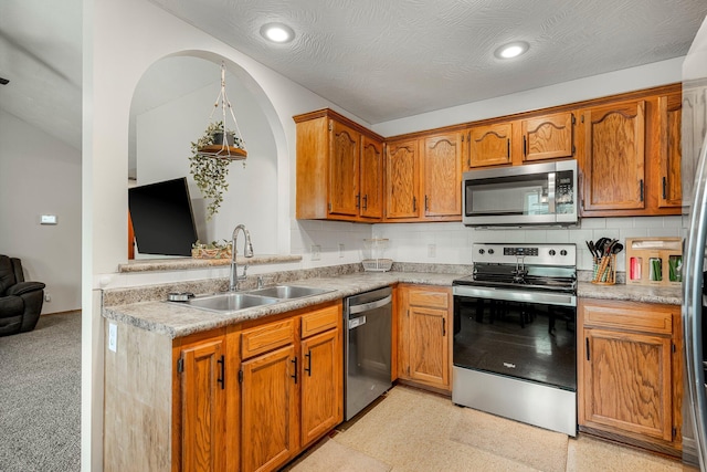 776 S Pinehurst St, Nixa, MO 65714 - kitchen with stainless steel appliances, a sink, light countertops, arched walkways, and backsplash