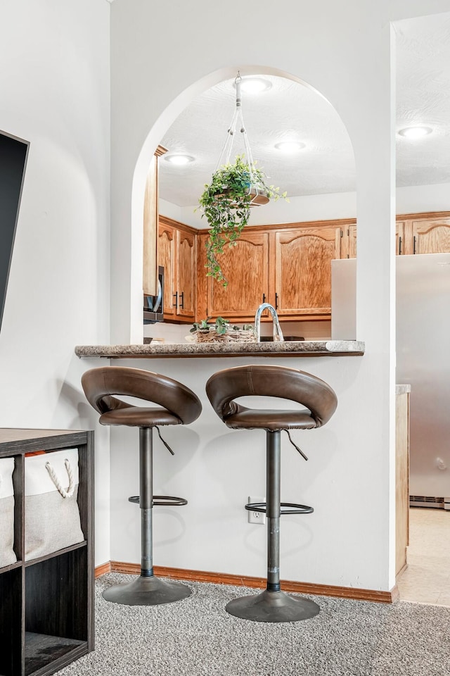 776 S Pinehurst St, Nixa, MO 65714 - bar with arched walkways, baseboards, and a sink