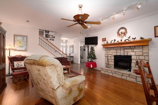 living room featuring ornamental molding, hardwood / wood-style floors, and a fireplace