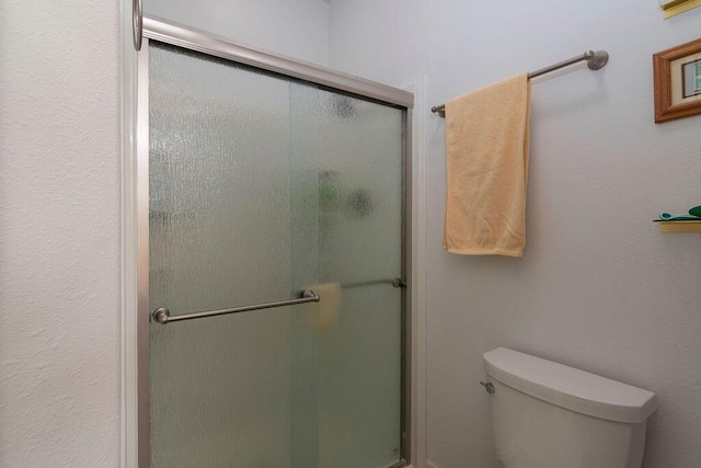 bathroom with walk in shower and toilet