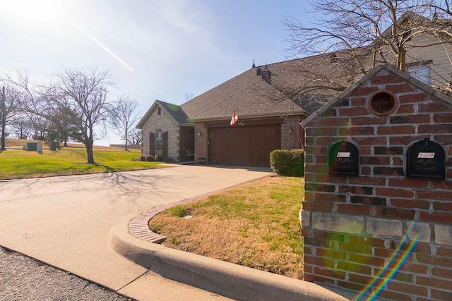 view of front of property featuring a garage and a front lawn