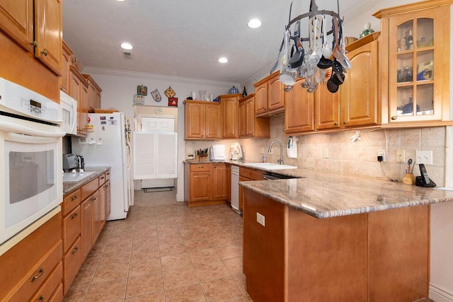 kitchen featuring decorative light fixtures, sink, ornamental molding, kitchen peninsula, and white appliances