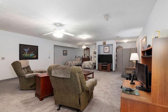 living room with ceiling fan and carpet flooring