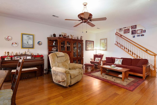 living room with crown molding, hardwood / wood-style flooring, and ceiling fan