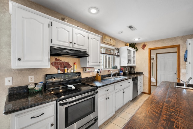 kitchen with white cabinetry, sink, light tile patterned floors, and appliances with stainless steel finishes