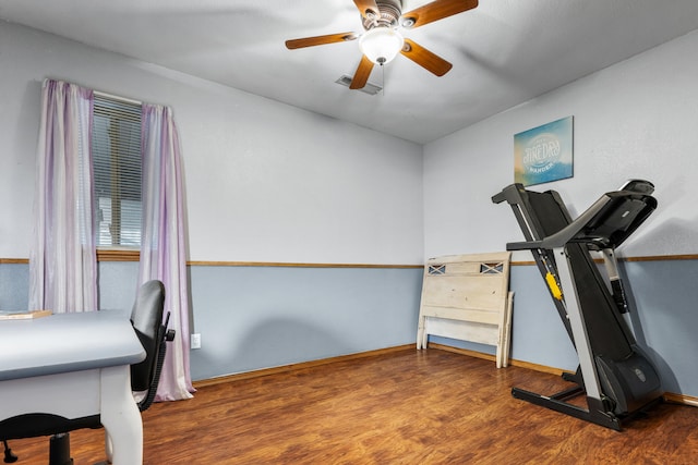 workout room with ceiling fan and hardwood / wood-style floors