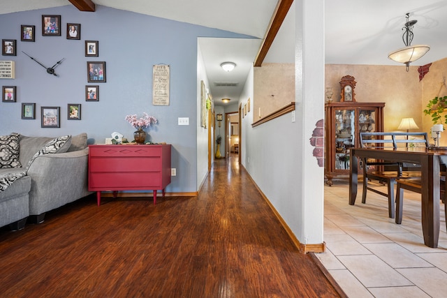 corridor featuring hardwood / wood-style floors and lofted ceiling with beams