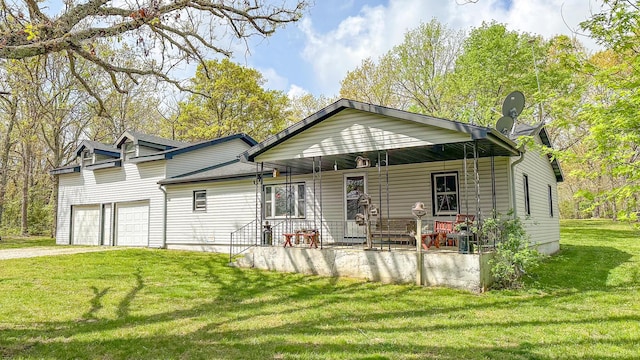 view of front of property with a porch, a front yard, dirt driveway, and a garage