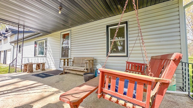 view of patio / terrace with a porch and a garage