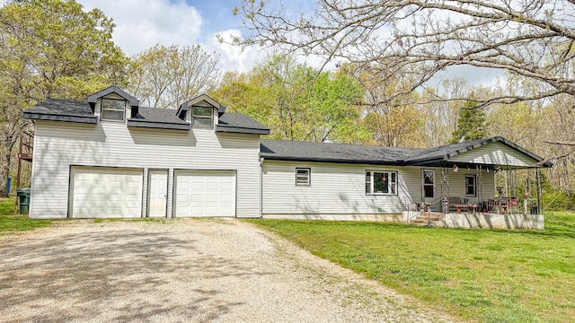 back of house with driveway, roof with shingles, an attached garage, a lawn, and a porch