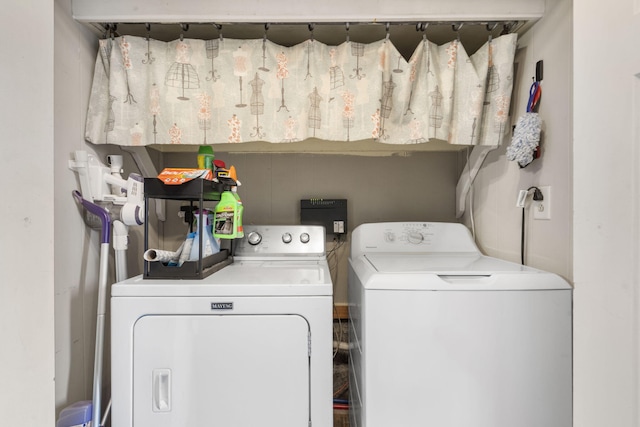 clothes washing area featuring independent washer and dryer