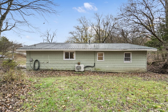 rear view of house featuring a lawn