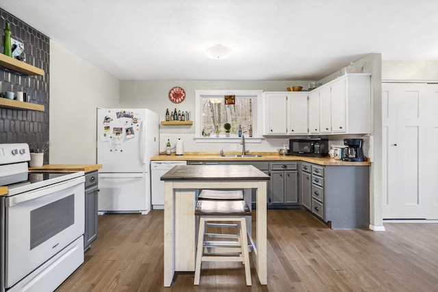 kitchen featuring white appliances, white cabinets, sink, gray cabinets, and butcher block countertops