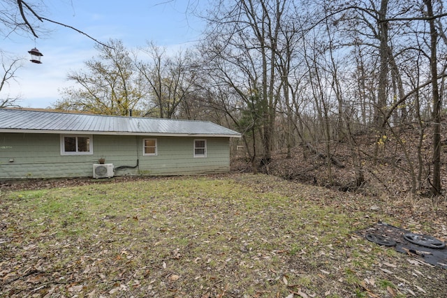 exterior space featuring a lawn and ac unit