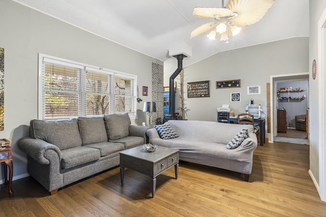 living room with ceiling fan, light hardwood / wood-style floors, and vaulted ceiling