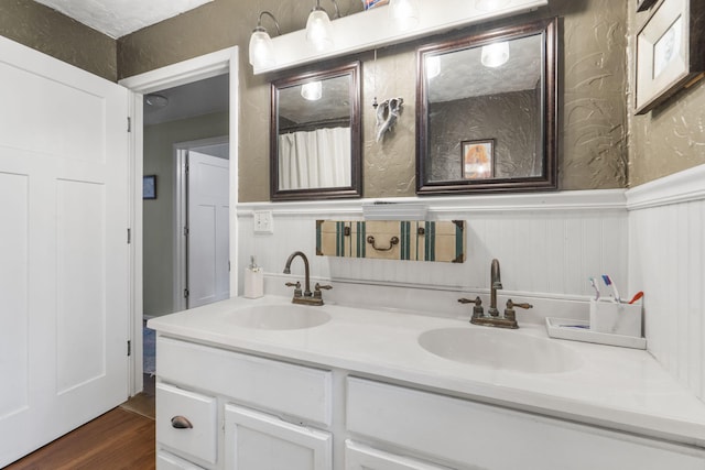 bathroom with hardwood / wood-style flooring and vanity