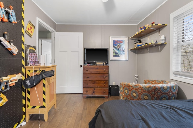 bedroom featuring hardwood / wood-style flooring and ornamental molding