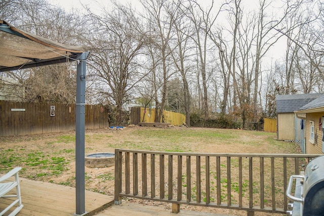 view of yard featuring a fire pit and a deck