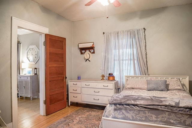 bedroom with ceiling fan and hardwood / wood-style flooring