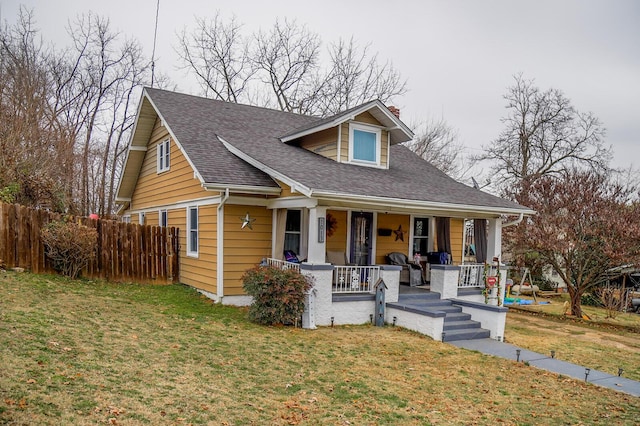 bungalow-style house with a front lawn and covered porch