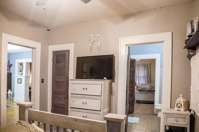 tiled bedroom featuring ceiling fan