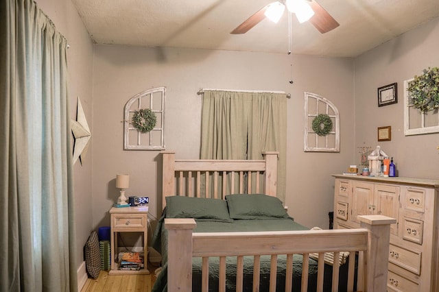 bedroom with ceiling fan and light hardwood / wood-style flooring