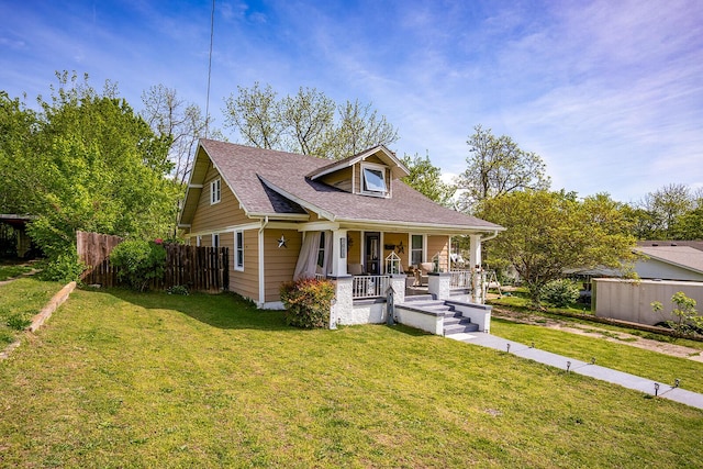 bungalow featuring a porch, a front lawn, roof with shingles, and fence