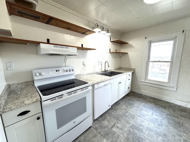 kitchen with white cabinetry, sink, light stone counters, extractor fan, and white appliances