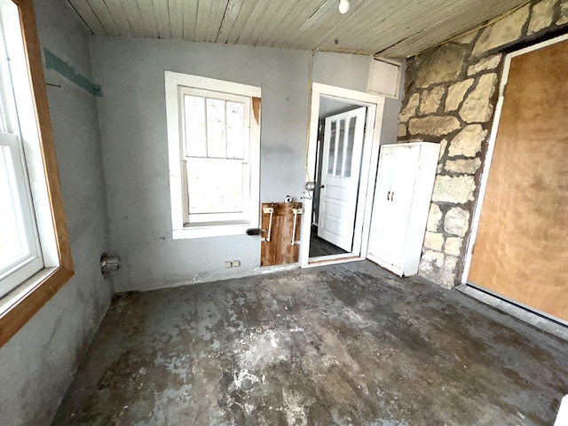 spare room featuring a healthy amount of sunlight and wood ceiling