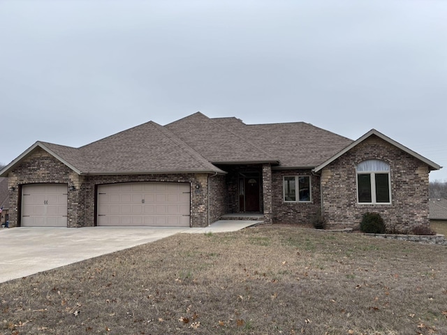 view of front of house with a garage and a front lawn