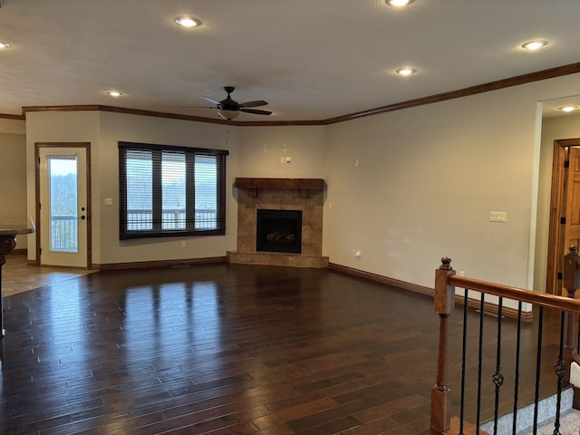 unfurnished living room with ceiling fan, dark hardwood / wood-style floors, and ornamental molding