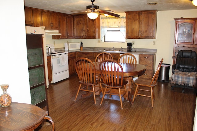 kitchen featuring white appliances, dark hardwood / wood-style floors, ceiling fan, and sink