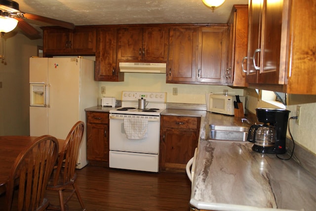 kitchen with dark hardwood / wood-style flooring, white appliances, a textured ceiling, ceiling fan, and sink